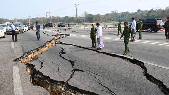 In this image provided by The Myanmar Military True News Information Team, Myanmar's military leader Senior Gen. Min Aung Hlaing, center, inspects damaged road caused by an earthquake Friday, March 28, 2025, in Naypyitaw, Myanmar. (The Myanmar Military True News Information Team via AP)